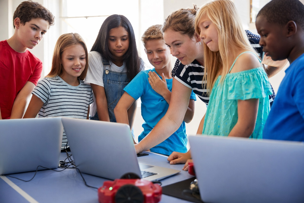 Afterschool program staff reviewing student participation and academic progress data to demonstrate measurable program impact
